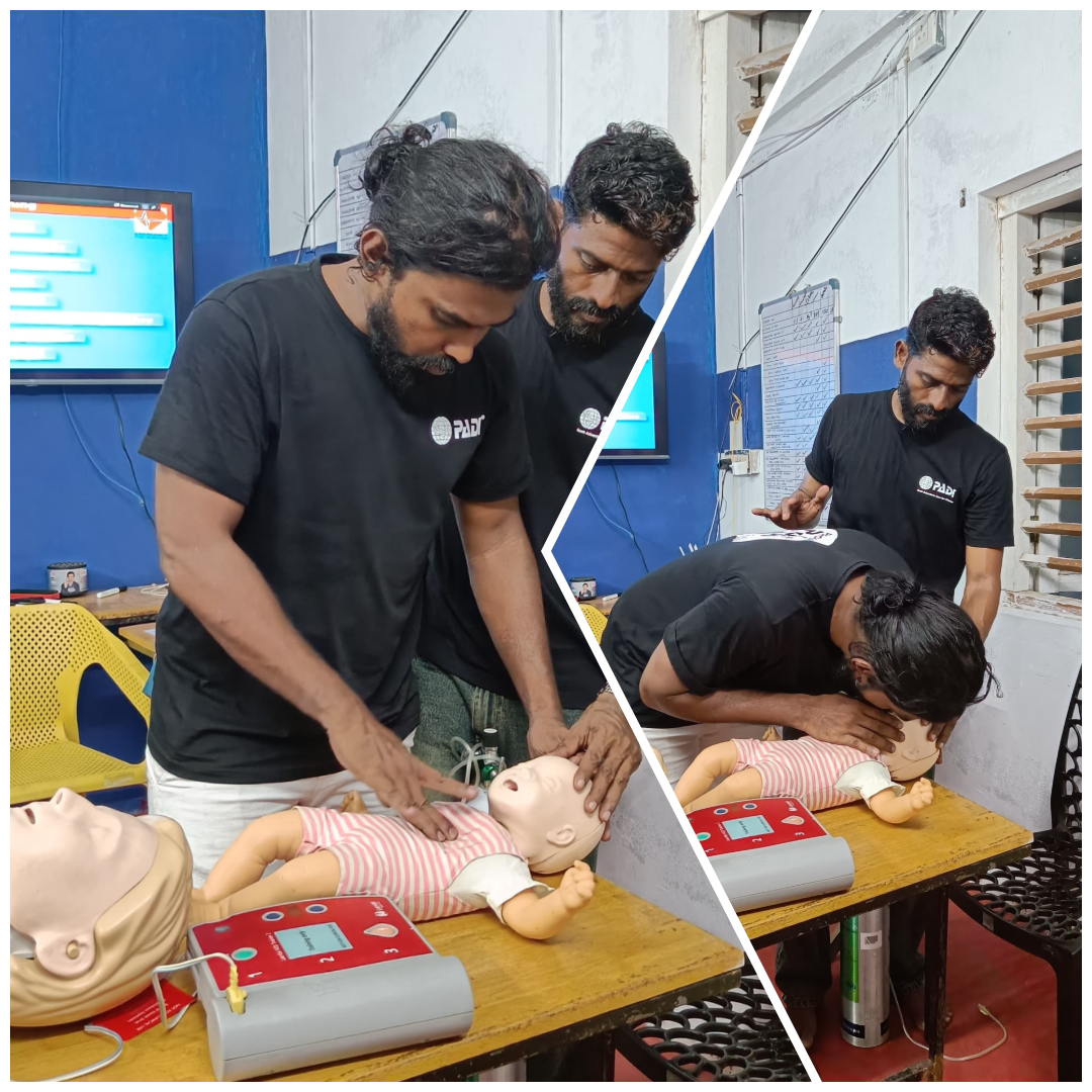PADI instructor practicing infant CPR during EFR training at Lak Scuba.